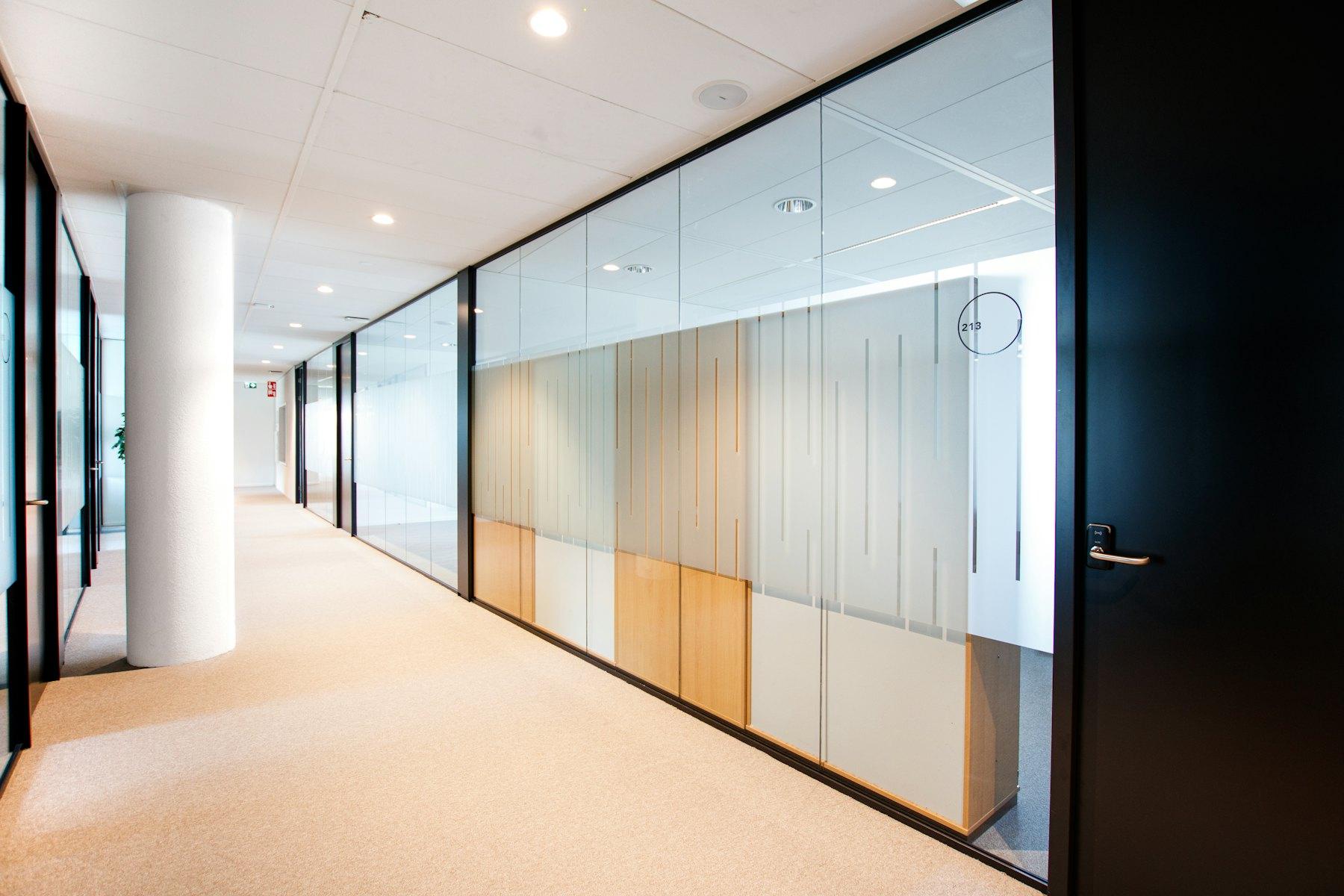 Office corridor lined with glass partitions