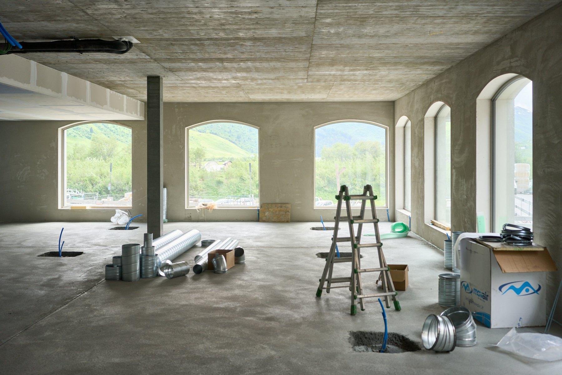 Commercial interior under renovation with ladder and materials